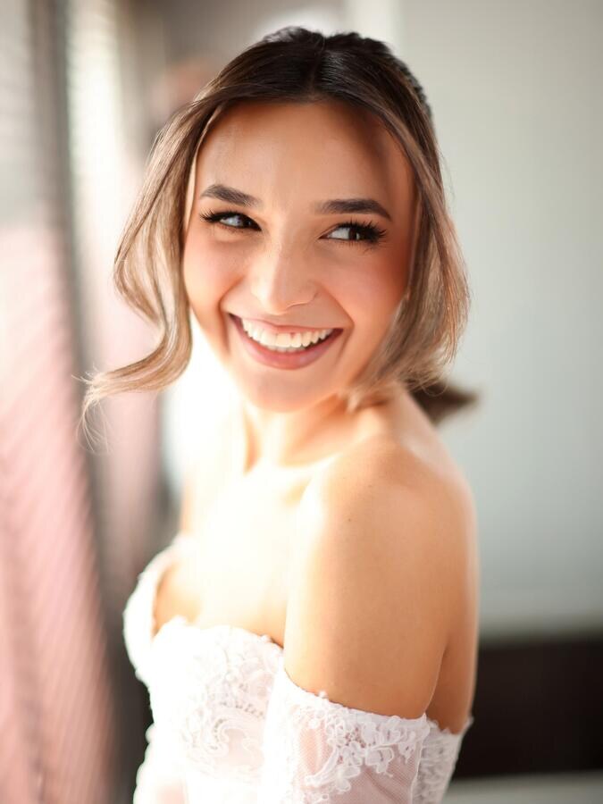 Bride smiling in warm window light