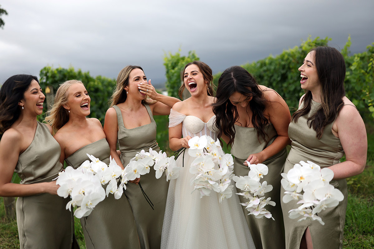 Bridesmaids laughing together in warm afternoon light