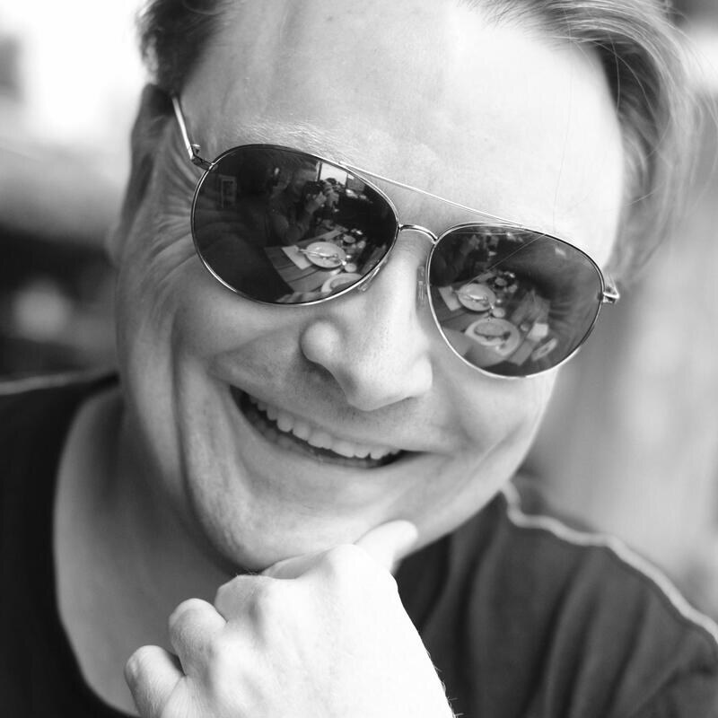 John Warren smiling in sunglasses
